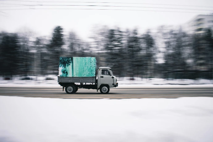 time lapse photography of white cab forward truck surrounded by snow